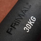 Black sandbag with 'PRIMAL' branding and '30KG' marking on a brown background in a gym.
