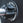 Close up view of a magnetic lockjaw collar securing a bumper plate in place on a barbell.
