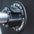 Close up view of a magnetic lockjaw collar securing a bumper plate in place on a barbell.