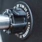 Close up view of a magnetic lockjaw collar securing a bumper plate in place on a barbell.