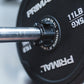 Close up view of a magnetic lockjaw collar securing a bumper plate in place on a barbell.