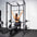 An athlete using the lat pulldown attachment on a home gym rack.