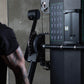 A close up of the cable pulley system on a dual arm functional trainer machine.