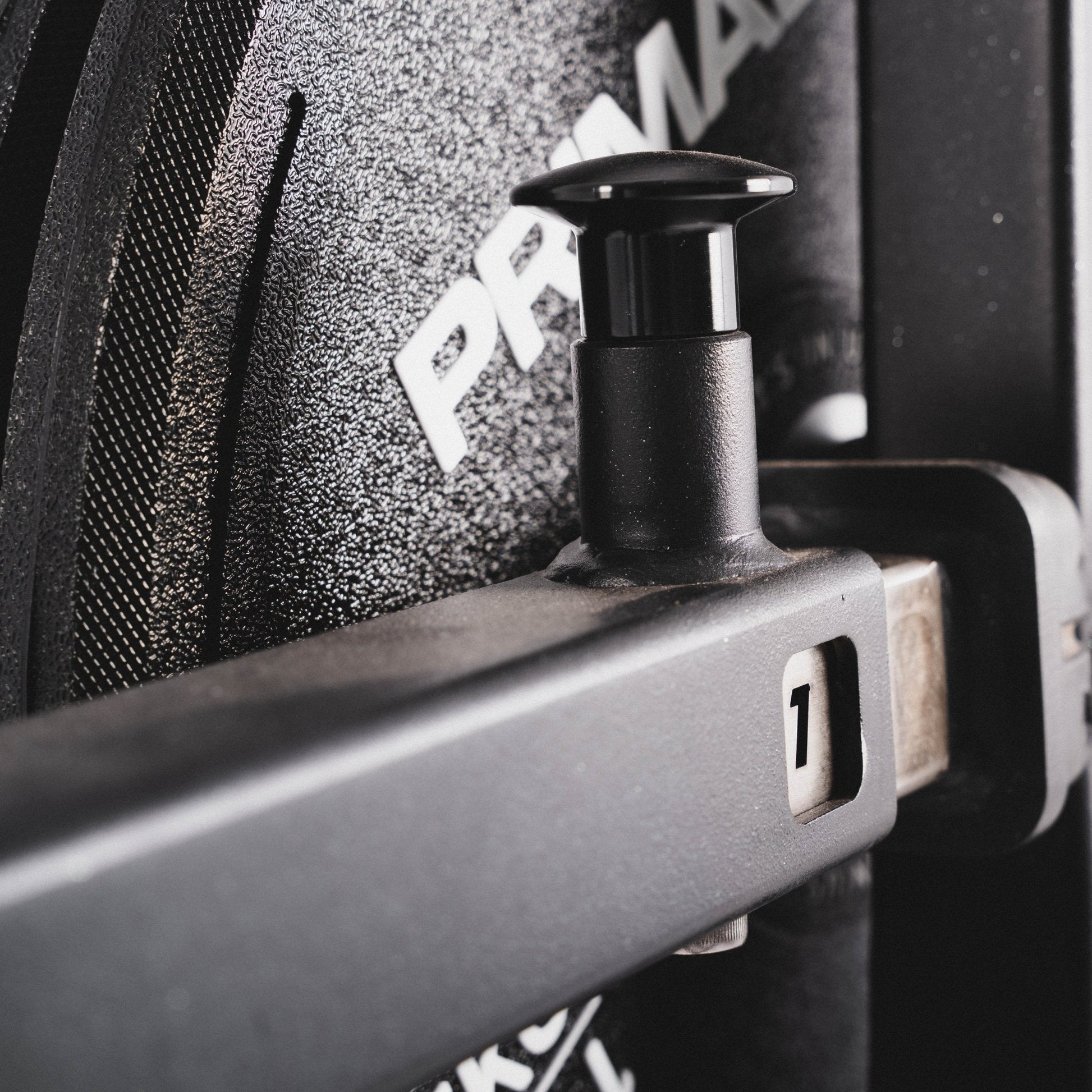 A pop pin for angle adjustment on a plate loaded rear kickback machine