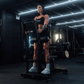 Athlete using plate-loaded standing hip thrust machine.