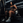 Athlete sitting on plate-loaded standing hip thrust machine.