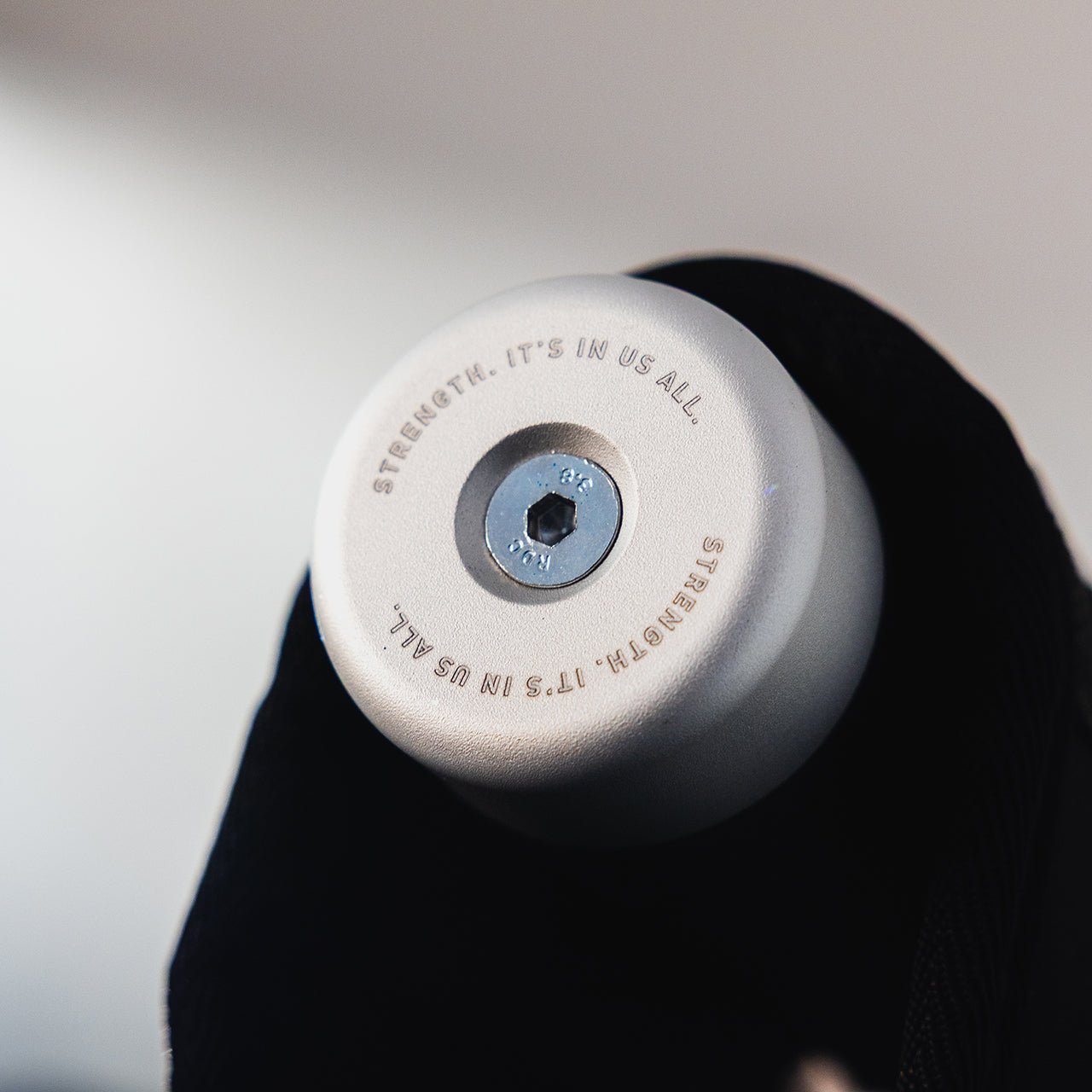 A close up of the PRIMAL branding on a plate loaded belt squat machine.
