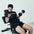 An athlete performing bicep curl using an elbow pad attachment on a weight bench.