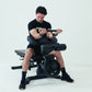 An athlete using a preacher curl attachment on a weight bench.