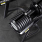 A top-down view of a 34kg adjustable dumbbell on a storage stand.