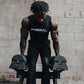 An athlete lifting a pair of 40kg adjustable dumbbells from a stand.