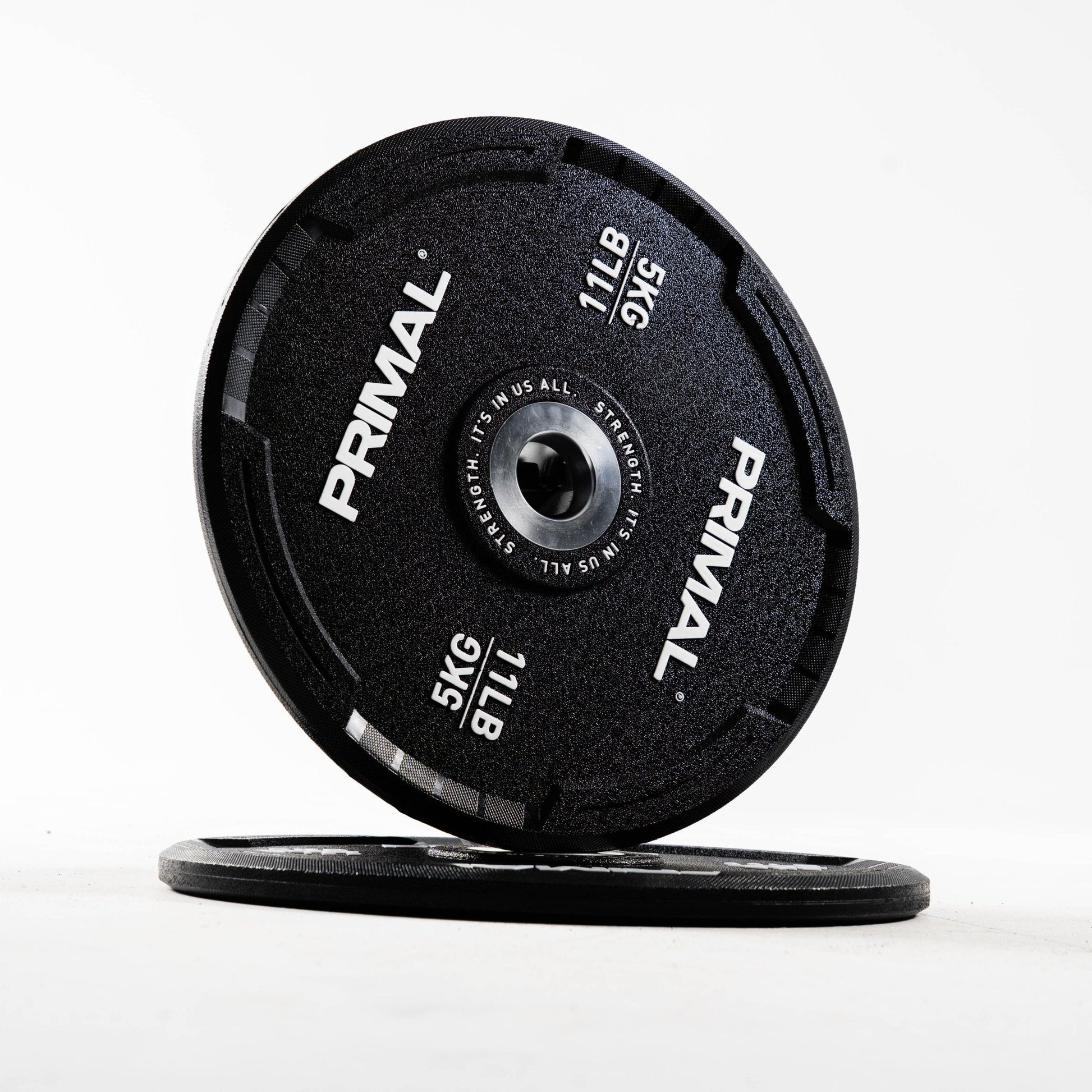 Two Primal bumper plates on a white background