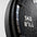 Close-up of a black weight plate with '5KG' and '11LB' text on a gray background
