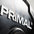 Close-up of a 'PRIMAL' logo on a black rubber bumper plate