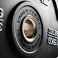 Close-up of a weight plate with motivational text and weight measurement.