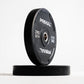 Two black Primal weight plates on a white background