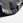 Close-up of a Grey & black bumper plate with a textured pattern on a light gray background