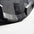 Close-up of a Grey & black bumper plate with a textured pattern on a light gray background