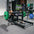 a woman performing hip thrusts with a hip thrust barbell and floor hip thrust bench