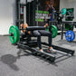 a woman performing hip thrusts with a hip thrust barbell and floor hip thrust bench