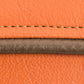 orange leather with brown stitching